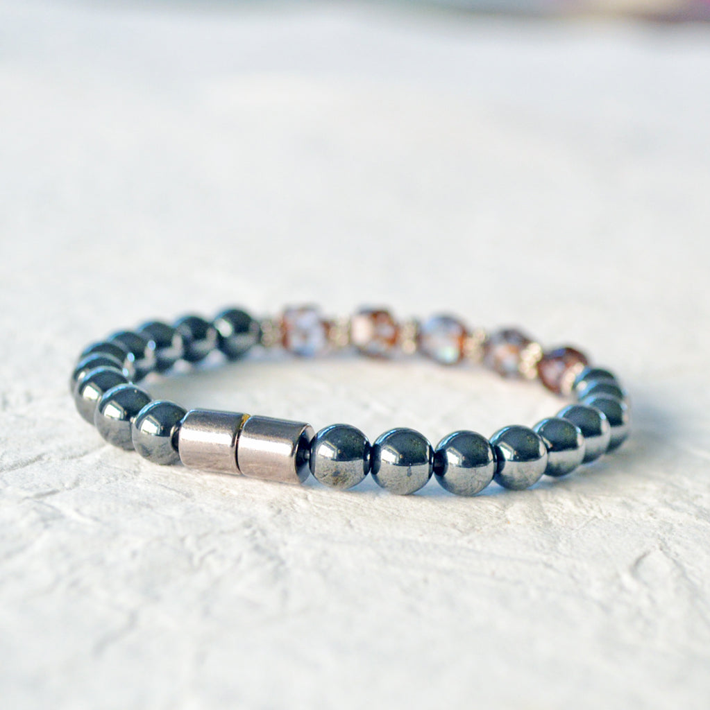 Magnetic hematite therapy bracelet handcrafted with powerful magnetic hematite beads. In the center are five alexandrite czech glass beads surrounded by antique silver spacer beads. Secured with a strong magnetic clasp.