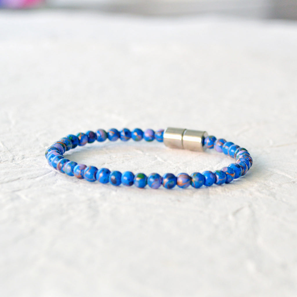 Magnetic bracelet handcrafted with blue picasso hematite magnetic beads and secured with a strong and easy-to-use rare earth magnetic clasp.