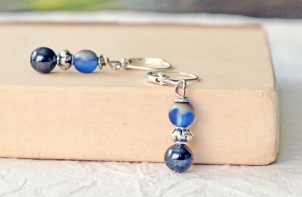 Magnetic bead earrings handcrafted with black high power magnetic hematite beads, pretty iridescent blue beads, and antique silver spacer beads. The beads all hang from antique silver leverbacks.