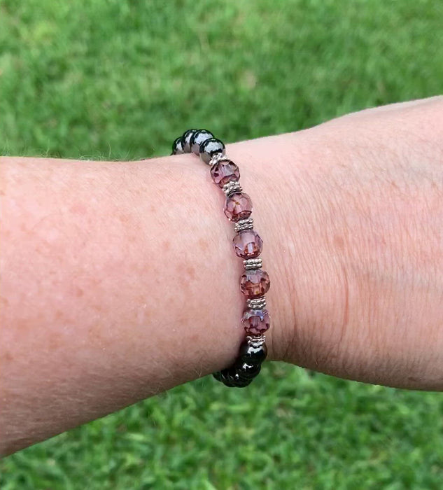 Magnetic hematite therapy bracelet handcrafted with powerful magnetic hematite beads. In the center are five alexandrite czech glass beads surrounded by antique silver spacer beads. Secured with a strong magnetic clasp.
