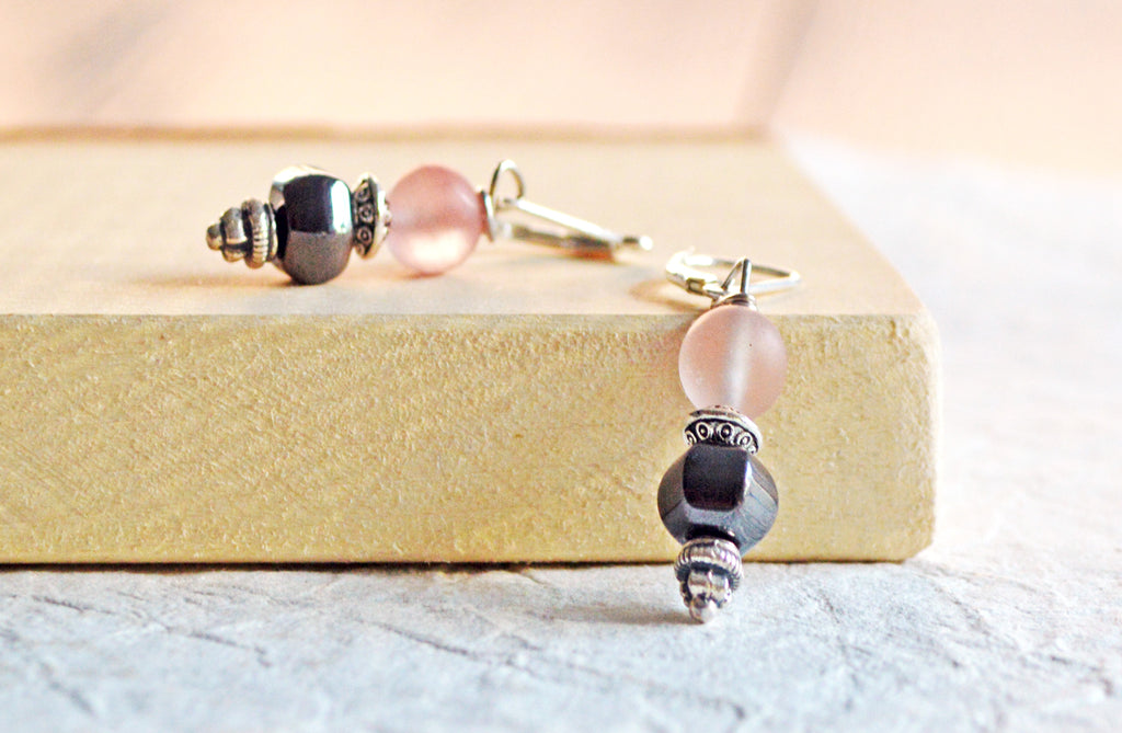 Magnetic earrings handcrafted with black high power magnetic hematite beads, pink quartz gemstone beads, and antique silver spacer beads. All beads hang from antique silver leverbacks.