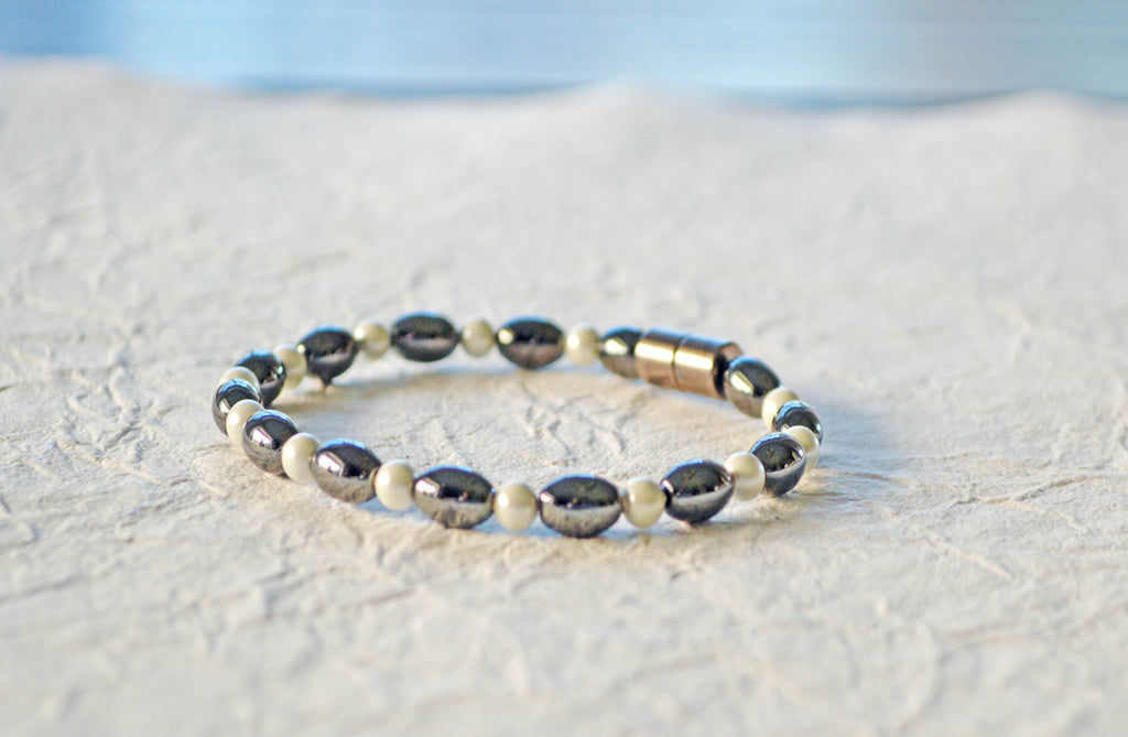 Magnetic bracelet is handcrafted with black and pearl hematite magnetic beads. Available in a variety of colors and secured with a strong and easy-to-use magnetic clasp.