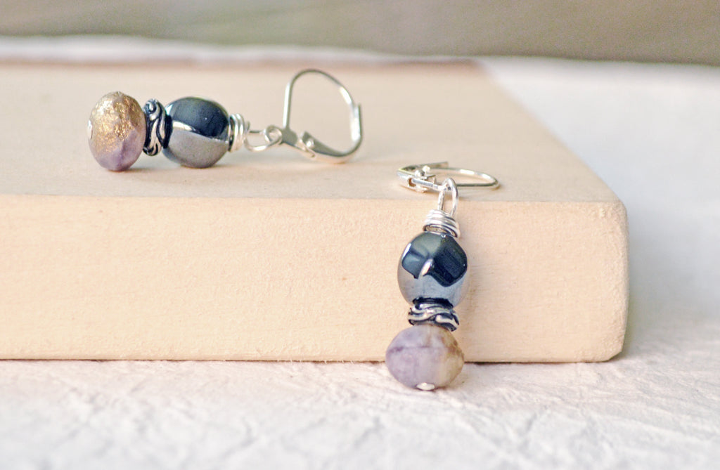 Magnetic earrings are handcrafted with black high power magnetic hematite earrings, purple/bronzed czech glass beads, and antique silver spacer beads. The beads all hang from antique silver leverbacks.