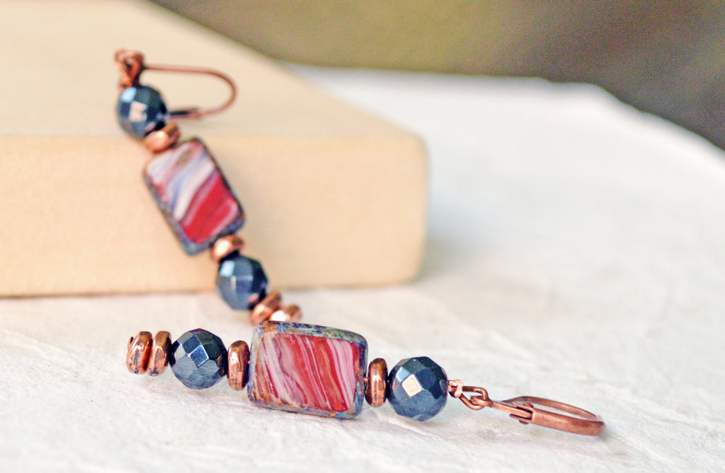 Magnetic earrings handcrafted with black high power magnetic hematite beads, red rectangular czech glass beads and antique copper spacer beads. The beads all hang from antique copper leverbacks.
