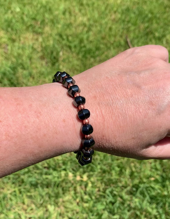 Magnetic bracelet handcrafted with black high power magnetic beads and genuine copper beads. It is secured with a strong and easy-to-use magnetic clasp.