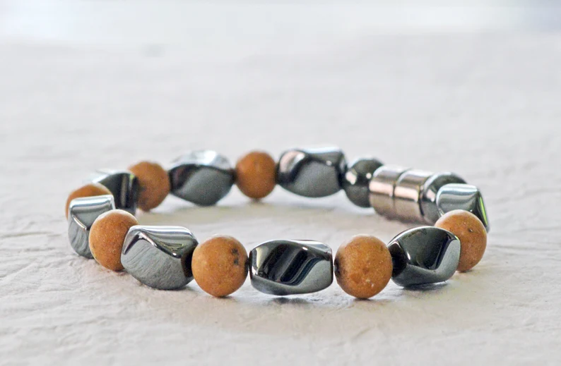 Magnetic bracelet is handcrafted with alternating black high power magnetic hematite beads and grain stone beads. It is secured with a strong and easy-to-use magnetic clasp.