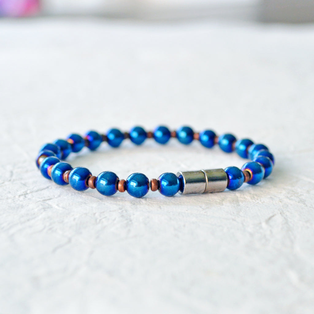 Magnetic bracelet handcrafted with blue metallic hematite magnetic beads and antique copper spacer beads. Secured with a strong magnetic clasp. Wear as a magnetic bracelet or magnetic anklet.