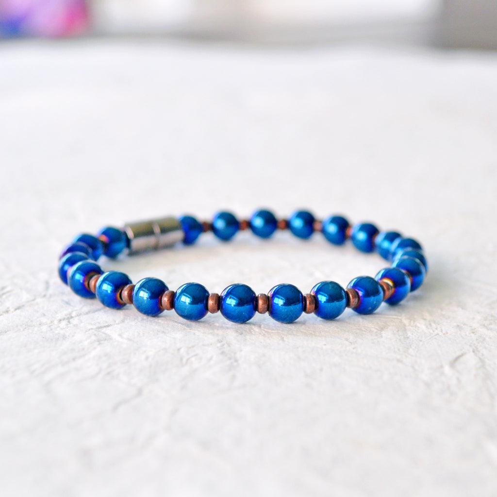 Magnetic bracelet handcrafted with blue metallic hematite magnetic beads and antique copper spacer beads. Secured with a strong magnetic clasp. Wear as a magnetic bracelet or magnetic anklet.