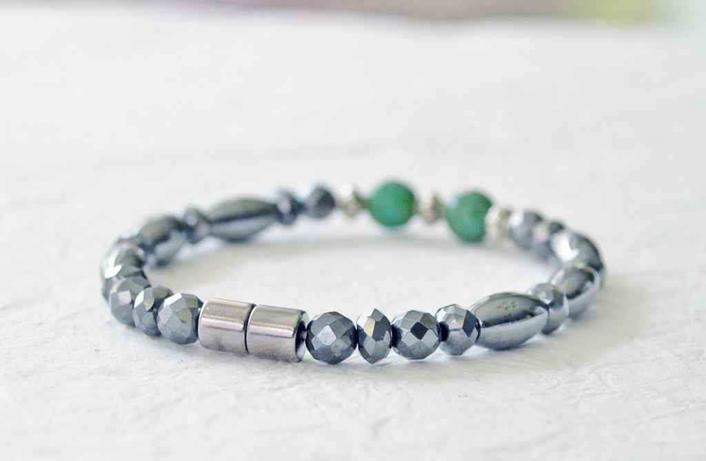 Magnetic bracelet handcrafted with black high power magnetic hematite beads with turquoise green gemstone beads and antique silver spacer beads. It is secured with a strong and easy-to=use magnetic clasp.