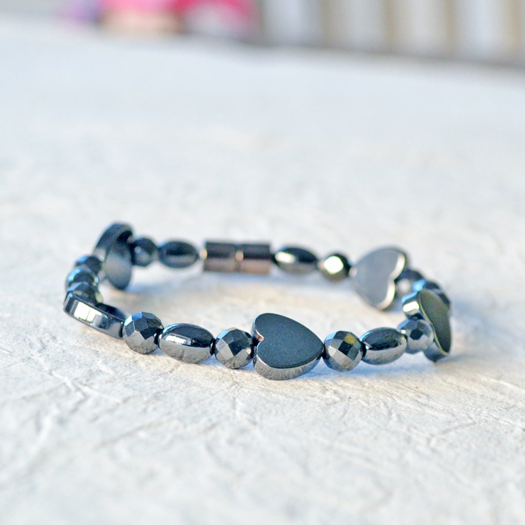 Magnetic bracelet handcrafted with black magnetic hematite beads in the shapes of hearts, round, and rice. It is secured with a strong and easy-to-use magnetic clasp.