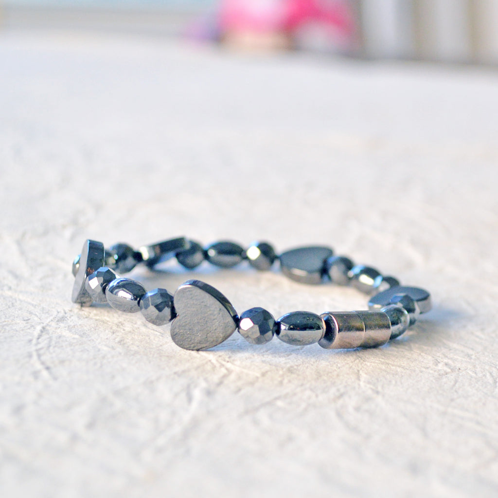 Magnetic bracelet handcrafted with black magnetic hematite beads in the shapes of hearts, round, and rice. It is secured with a strong and easy-to-use magnetic clasp.