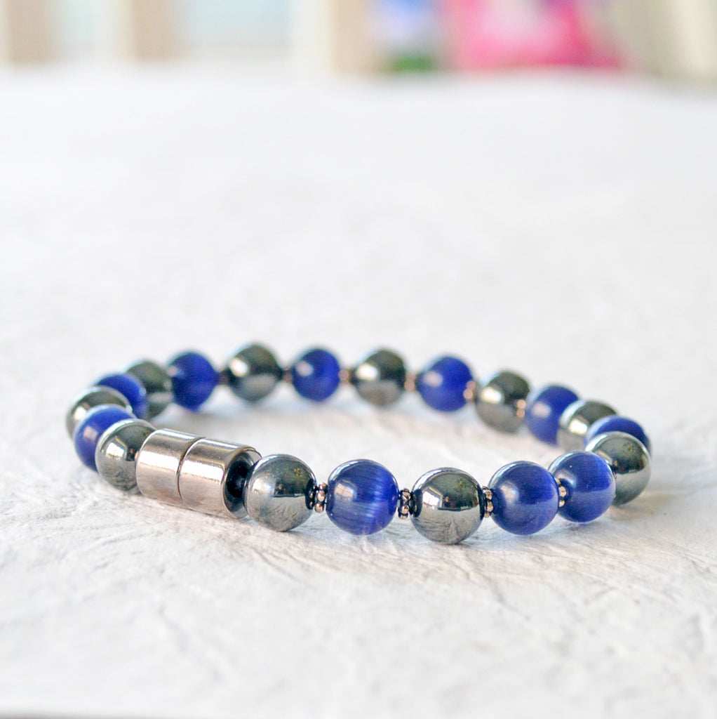 Magnetic bracelet handcrafted with alternating black magnetic hematite and blue cat's eye beads. Secured with a strong and easy-to-use magnetic clasp.