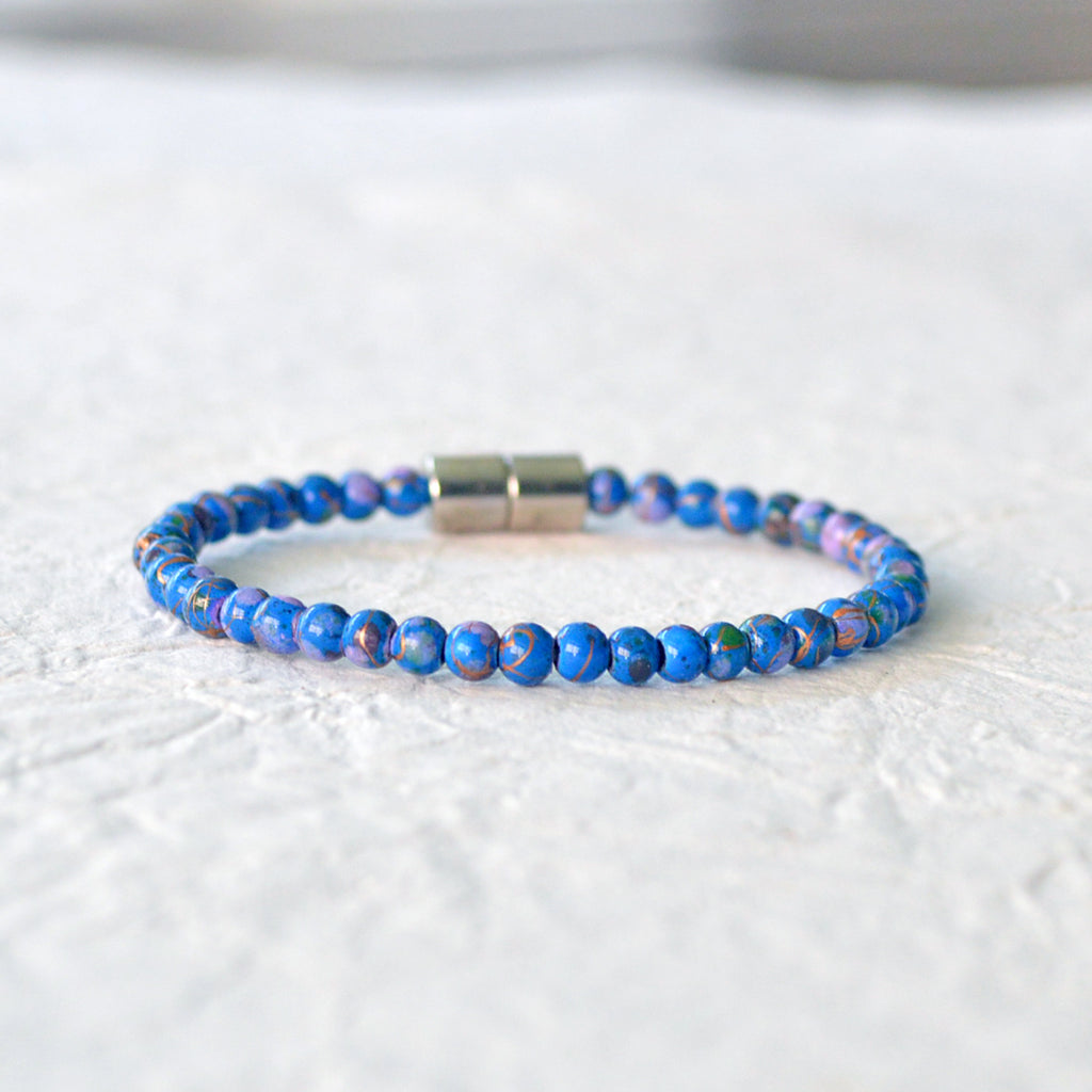 Magnetic bracelet handcrafted with blue picasso hematite magnetic beads and secured with a strong and easy-to-use rare earth magnetic clasp.