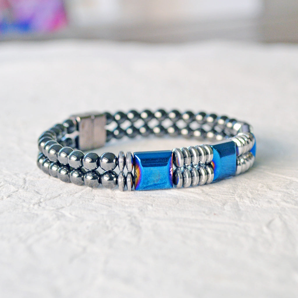 Double strand Magnetic bracelet handcrafted with blue and silver metallic magnetic beads, and black magnetic beads. It is secured with a strong rare earth magnetic clasp.