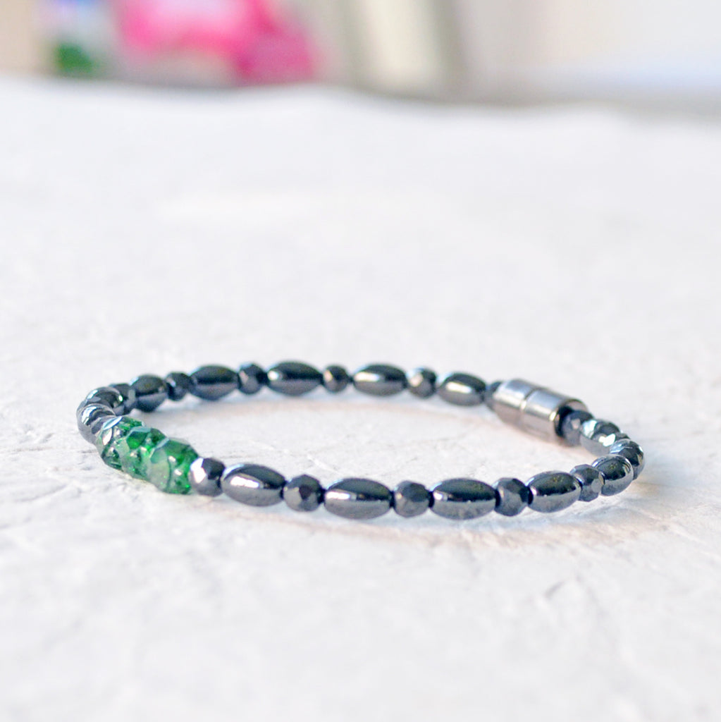Black magnetic bracelet handcrafted with powerful black magnetic hematite and green firepolish beads. Secured with a strong magnetic clasp. Wear as a magnetic bracelet or magnetic ankle bracelet.