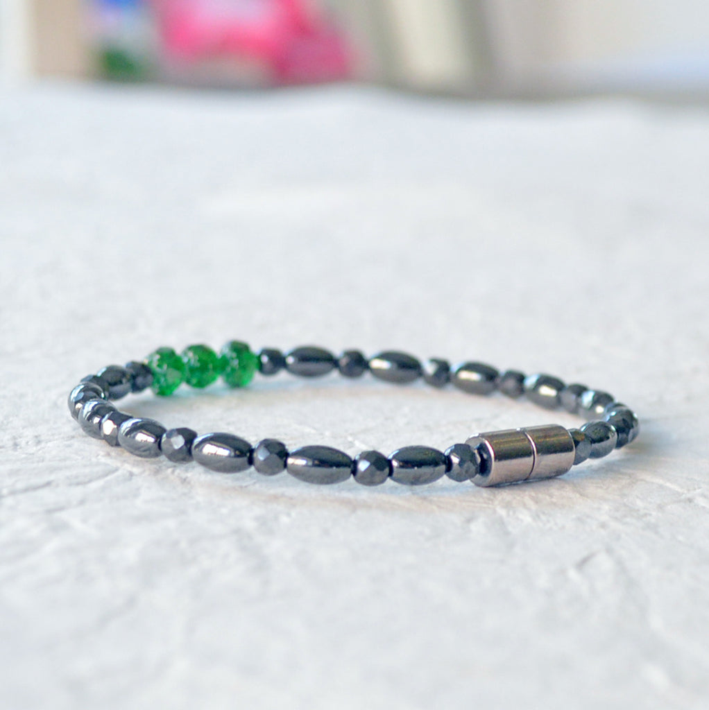 Black magnetic bracelet handcrafted with powerful black magnetic hematite and green firepolish beads. Secured with a strong magnetic clasp. Wear as a magnetic bracelet or magnetic ankle bracelet.