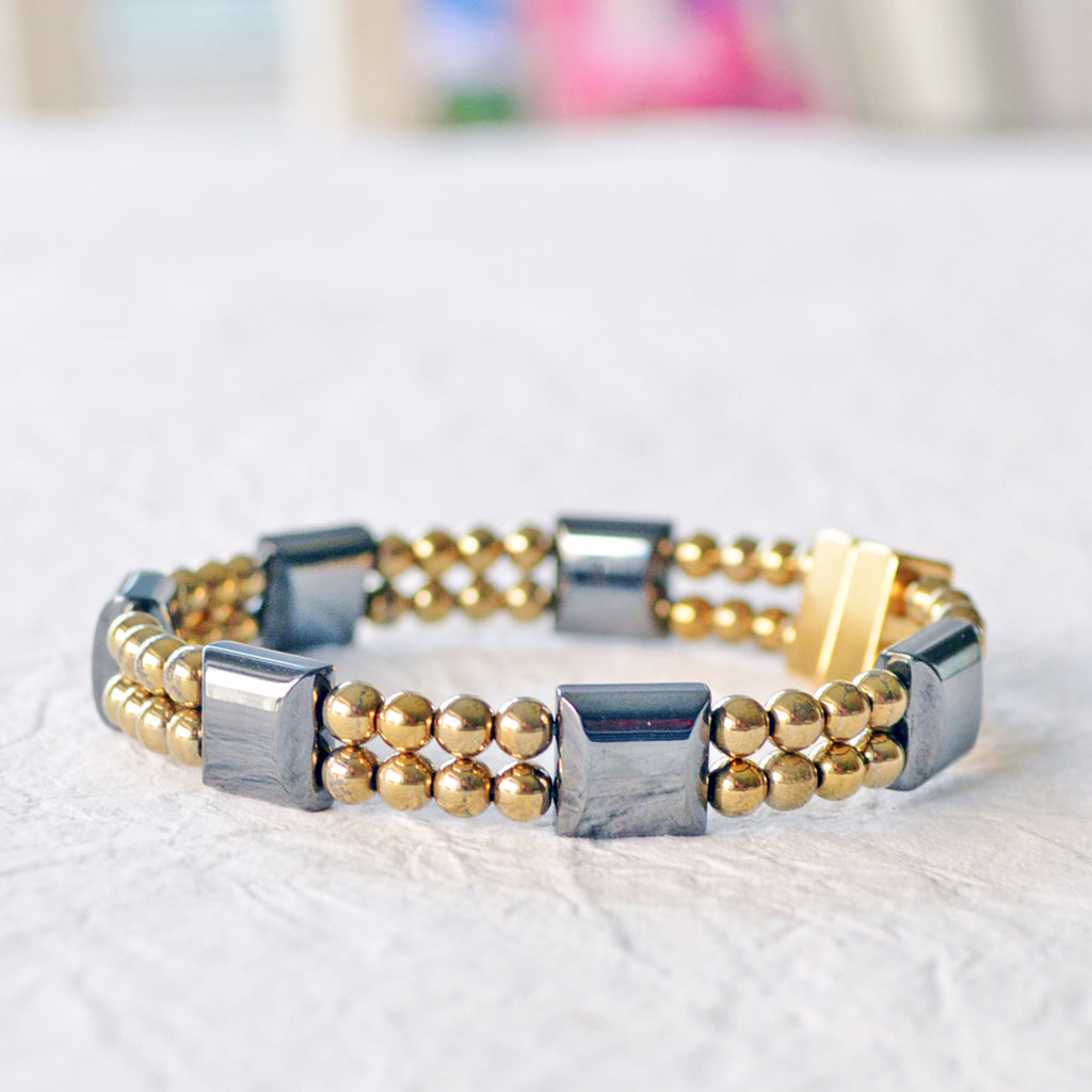 Double strand magnetic bracelet handcrafted with black and gold magnetic hematite beads. It is secured with a strong and easy-to-use magnetic clasp.