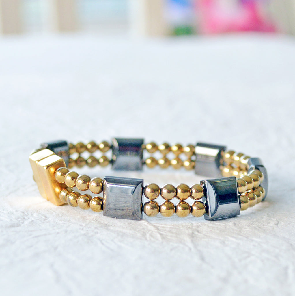 Double strand magnetic bracelet handcrafted with black and gold magnetic hematite beads. It is secured with a strong and easy-to-use magnetic clasp.