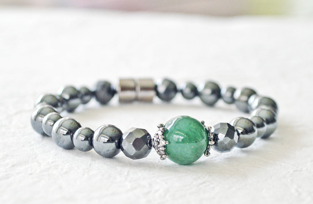 Magnetic bracelet handcrafted with black high power magnetic hematite beads with a green agate gemstone in the center. It is secured with a strong and easy-to-use magnetic clasp.