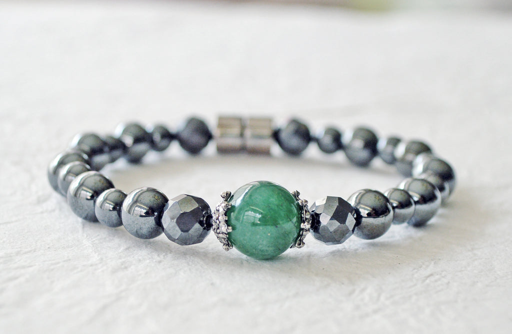 Magnetic bracelet handcrafted with black high power magnetic hematite beads with a green agate gemstone in the center. It is secured with a strong and easy-to-use magnetic clasp.