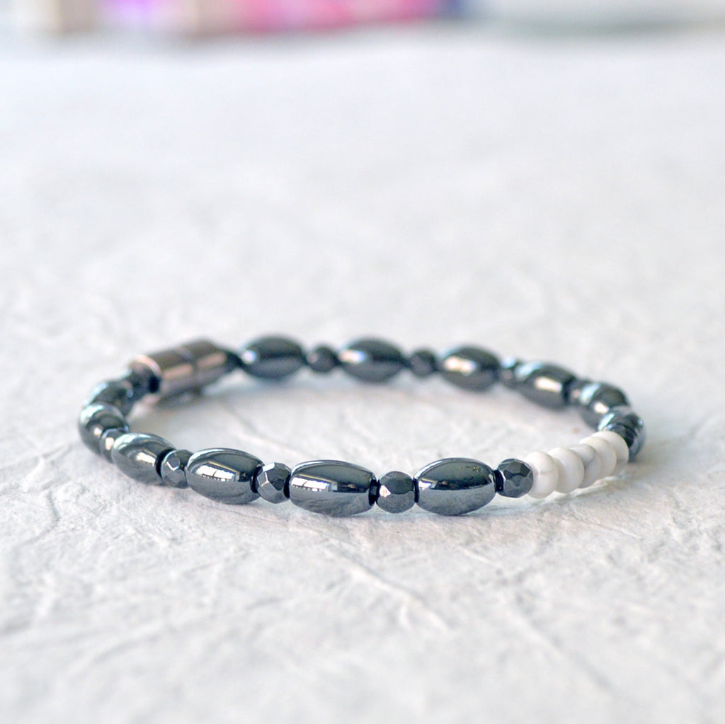 Magnetic bracelet handcrafted with black high power magnetic hematite bead with 5 white howlite rondelle beads in the center. Secured with a strong magnetic clasp.