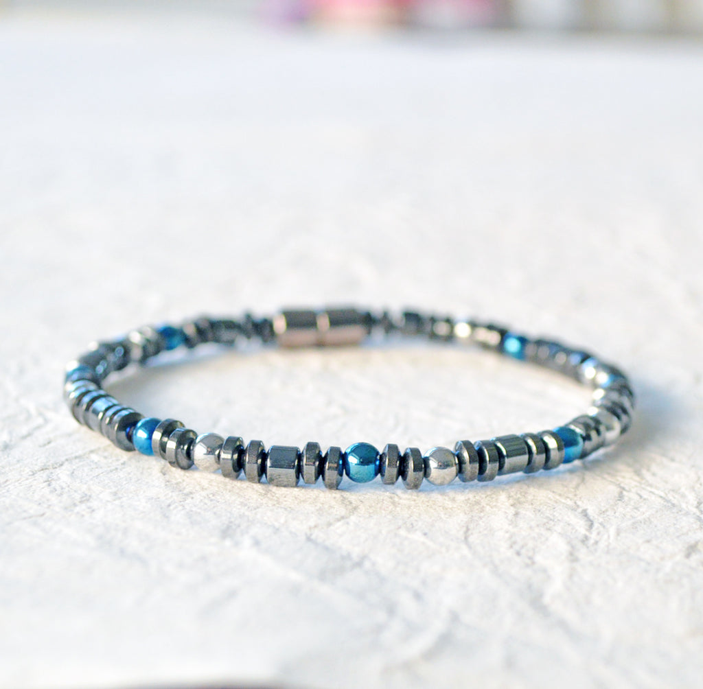 Hematite magnetic bracelet handcrafted with black, silver, and blue magnetic hematite beads. Secured with a strong magnetic clasp. Wear as a magnetic bracelet or magnetic ankle bracelet.