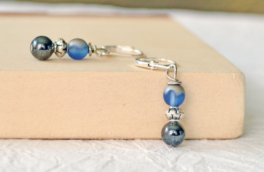 Magnetic bead earrings handcrafted with black high power magnetic hematite beads, pretty iridescent blue beads, and antique silver spacer beads. The beads all hang from antique silver leverbacks.
