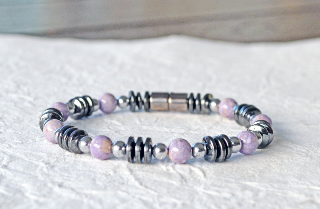 Magnetic bracelet handcrafted with black magnetic hematite beads, silver metallic magnetic hematite beads, and purple riverstone beads. It is secured with a strong and easy-to-use magnetic clasp.