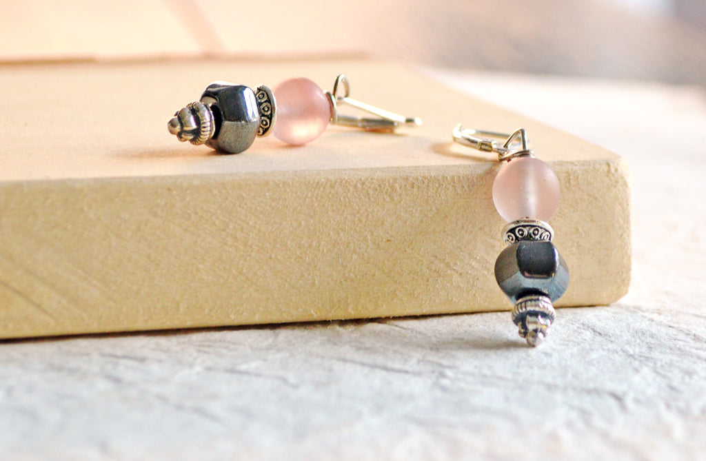 Magnetic earrings handcrafted with black high power magnetic hematite beads, pink quartz gemstone beads, and antique silver spacer beads. All beads hang from antique silver leverbacks.