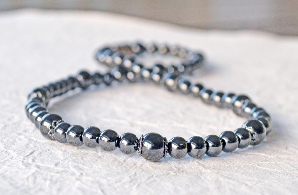 Magnetic Necklace handcrafted with black high power magnetic hematite beads and gunmetal pewter bead caps. Magnetic necklace is secured with a strong and easy-to-use magnetic clasp.