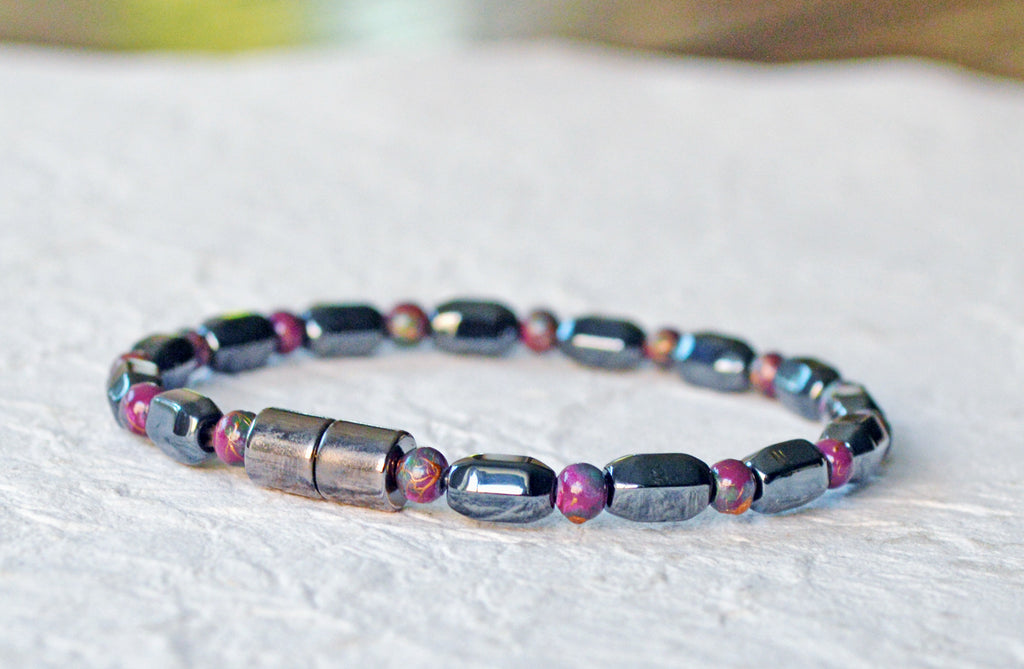 Magnetic bracelet is handcrafted with alternating black and burgundy magnetic hematite beads. It is secured with a strong and easy-to-use magnetic clasp.