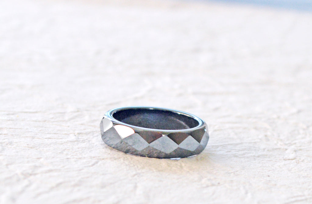 Black magnetic ring with faceted design.