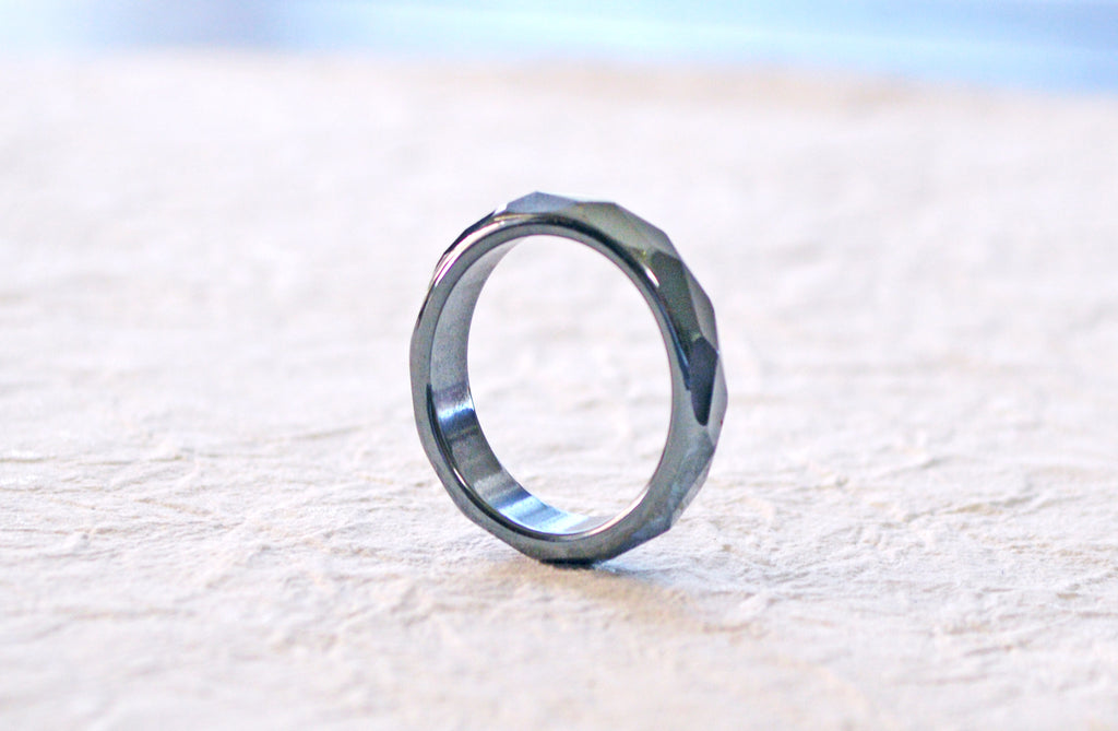 Black magnetic ring with faceted design.