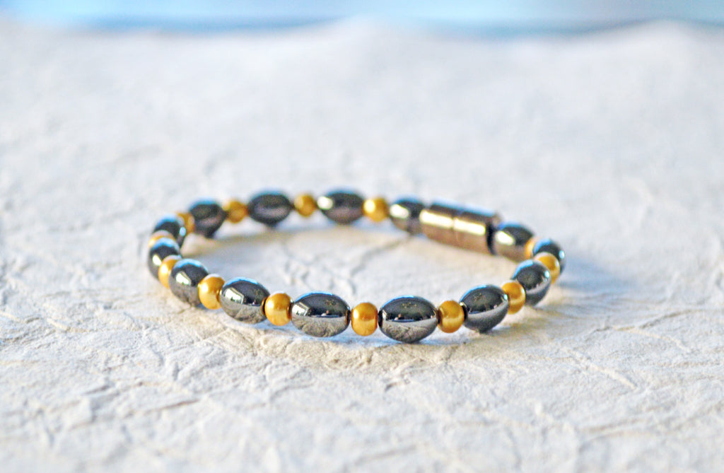 Magnetic bracelet is handcrafted with black and pearl hematite magnetic beads. Available in a variety of colors and secured with a strong and easy-to-use magnetic clasp.