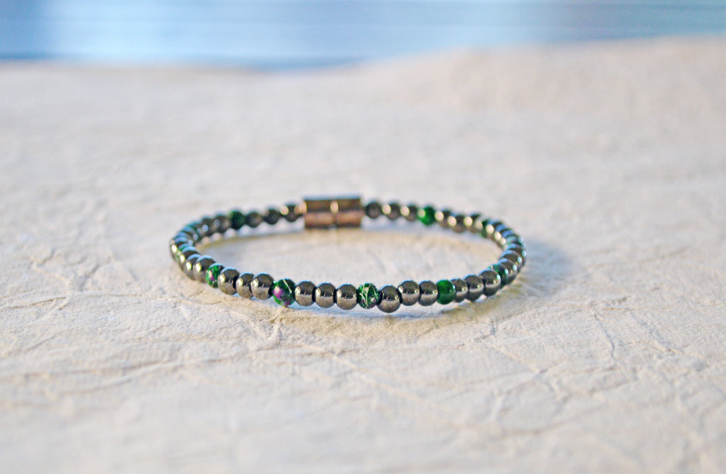 Magnetic bracelet handcrafted with black high power and green picasso magnetic hematite beads. It is secured with a strong and easy-to-use magnetic clasp.