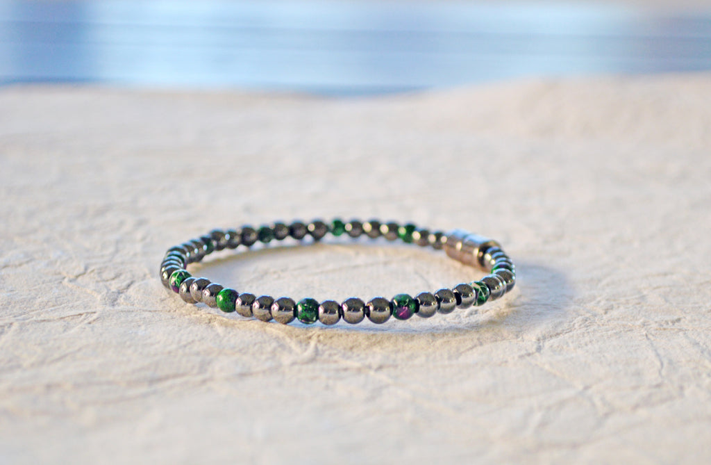 Magnetic bracelet handcrafted with black high power and green picasso magnetic hematite beads. It is secured with a strong and easy-to-use magnetic clasp.