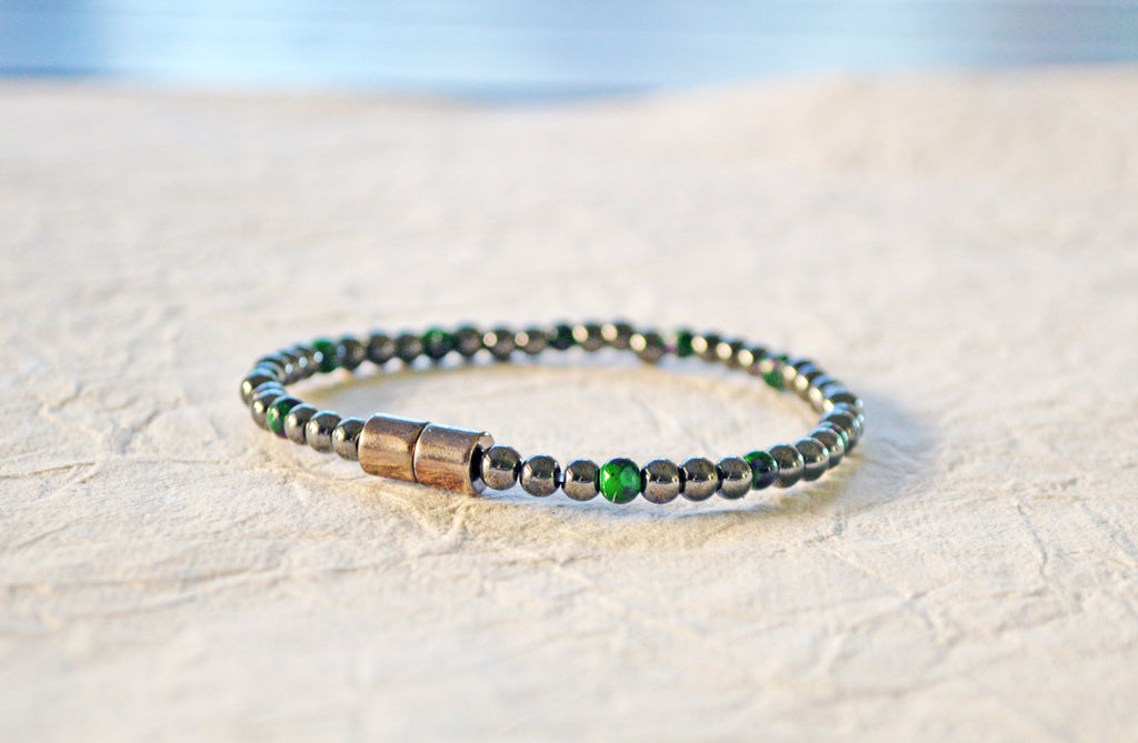 Magnetic bracelet handcrafted with black high power and green picasso magnetic hematite beads. It is secured with a strong and easy-to-use magnetic clasp.