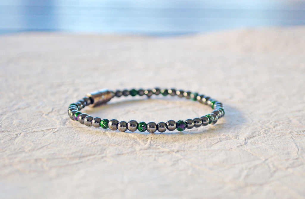 Magnetic bracelet handcrafted with black high power and green picasso magnetic hematite beads. It is secured with a strong and easy-to-use magnetic clasp.