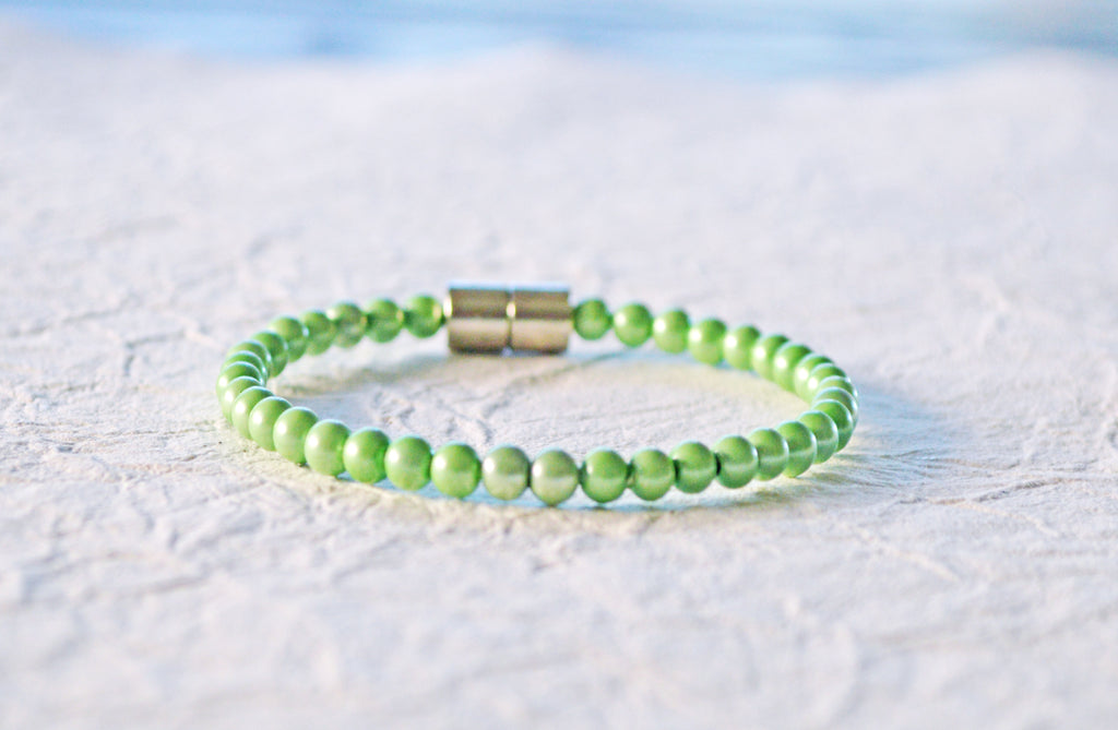 Magnetic bracelet handcrafted with mint green pearl hematite magnetic beads and secured with a strong and easy-to-use rare earth magnetic clasp.