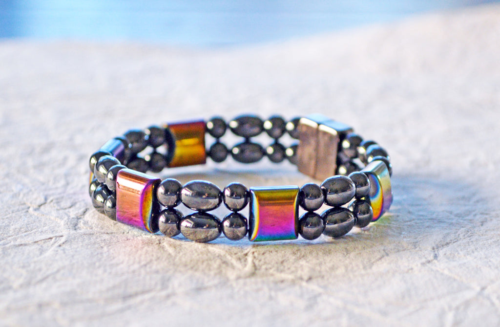 Magnetic bracelet handcrafted with a double strand of black and iridescent rainbow hematite magnetic beads. It is secured with a strong and easy-to-use magnetic clasp.