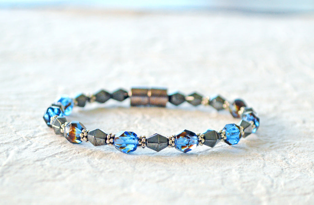 Magnetic bracelet handcrafted with black magnetic hematite beads, sapphire blue czech glass beads, and antique silver spacer beads. It is secured with a strong and easy-to-use magnetic clasp.