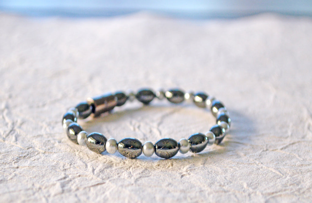 Magnetic bracelet is handcrafted with black and pearl hematite magnetic beads. Available in a variety of colors and secured with a strong and easy-to-use magnetic clasp.