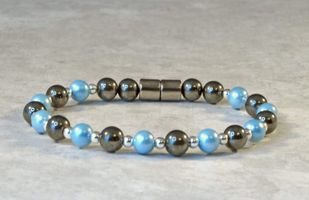 Magnetic bracelet is handcrafted with black high power and aqua blue pearl magnetic hematite beads. The bracelet is secured with a strong and easy-to-use magnetic clasp.