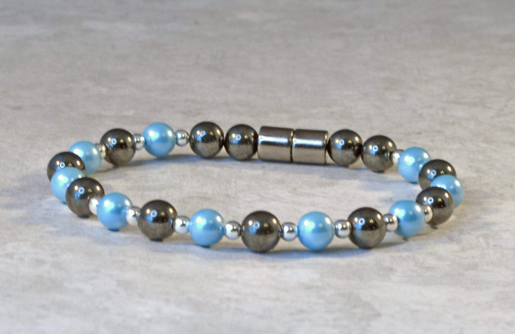 Magnetic bracelet is handcrafted with black high power and aqua blue pearl magnetic hematite beads. The bracelet is secured with a strong and easy-to-use magnetic clasp.