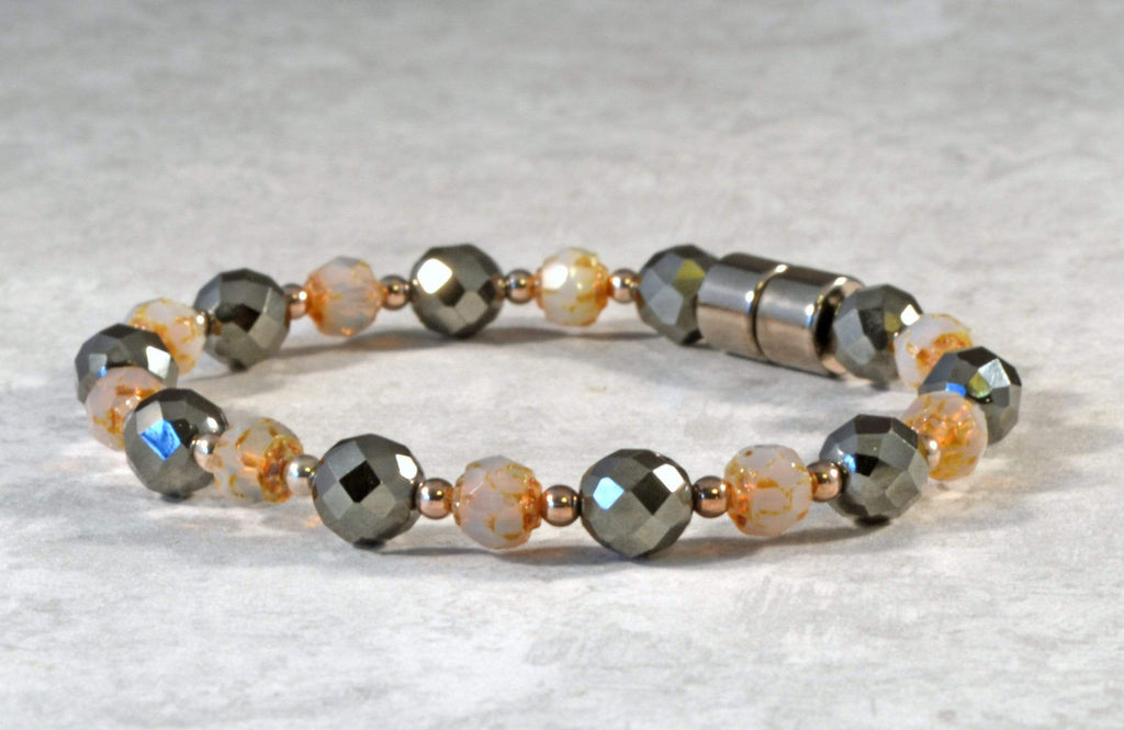 Magnetic bracelet is handcrafted with black high power magnetic hematite beads, topaz opal czech glass baroque firepolished, and sterling silver beads. It is secured with a strong and easy-to-use magnetic clasp.