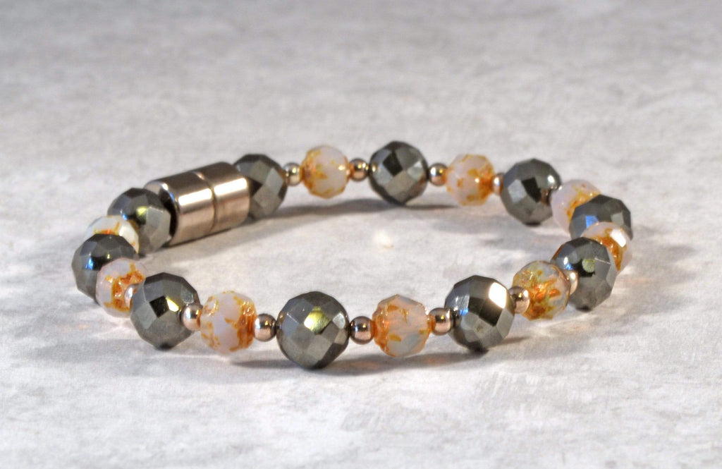 Magnetic bracelet is handcrafted with black high power magnetic hematite beads, topaz opal czech glass baroque firepolished, and sterling silver beads. It is secured with a strong and easy-to-use magnetic clasp.