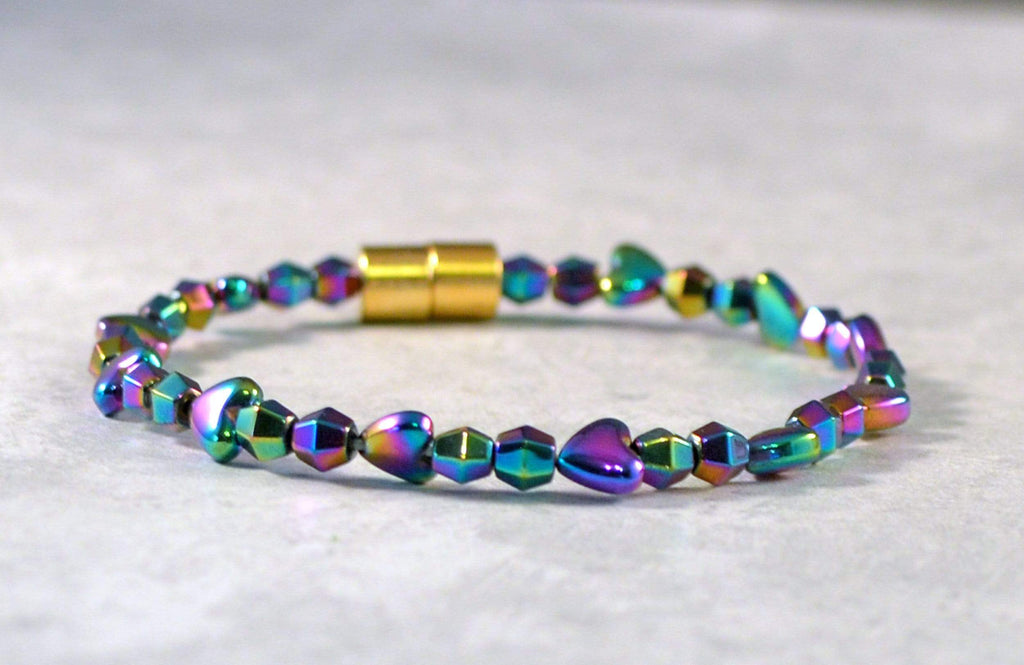 Magnetic bracelet handcrafted with iridescent rainbow hematite magnetic beads in the shapes of hearts and diamonds. Magnetic bracelet is secured with a strong and easy-to-use magnetic clasp.