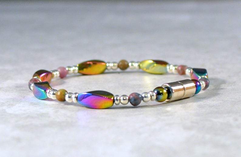 Magnetic bracelet handcrafted with iridescent rainbow hematite magnetic beads with ruby kyanite gemstone beads and antique silver spacer beads. It is secured with a strong and easy-to-use magnetic clasp.