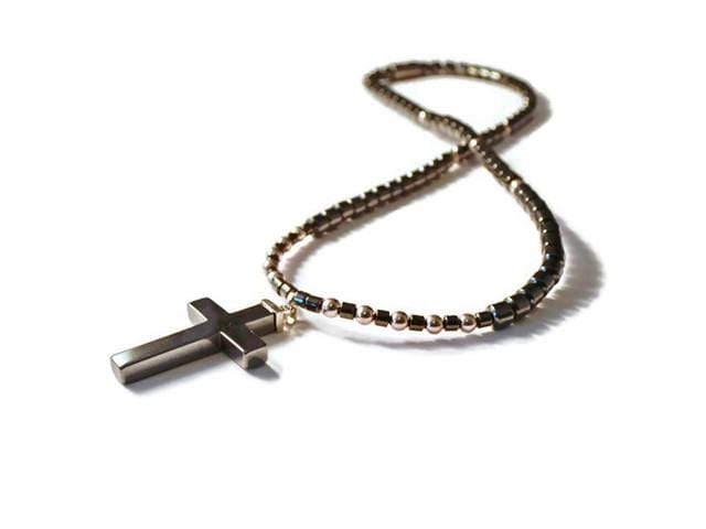 Magnetic necklace handcrafted with black high power magnetic hematite beads, sterling silver beads, and a black hematite cross pendant. It is secured with a strong and easy-to-use rare earth magnetic clasp.