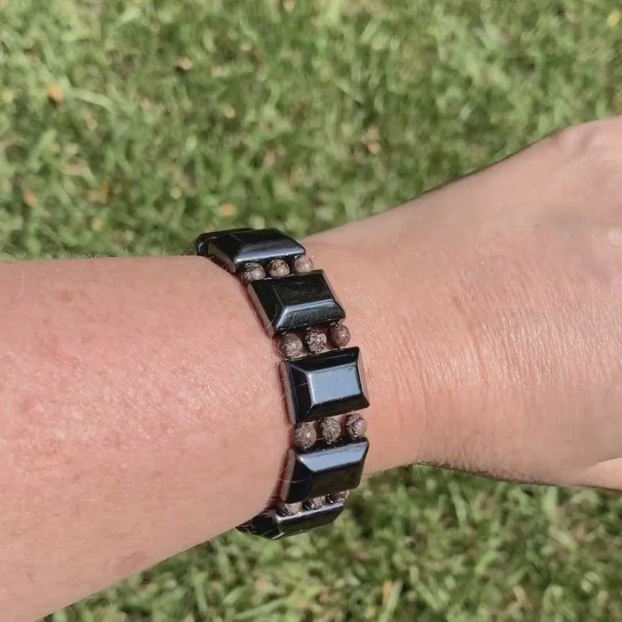 Magnetic bracelet handcrafted with black magnetic hematite beads and snowflake jasper gemstone beads. It is secured with a strong and easy-to-use rare earth magnetic clasp.